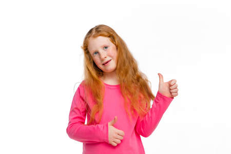 Thumbs up. Happy, smiley redhair girl isolated on white studio background with copyspace for ad....