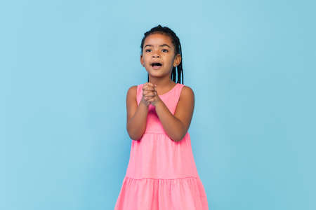 Love. Happy longhair brunette little girl isolated on blue studio background with copyspace for ad....