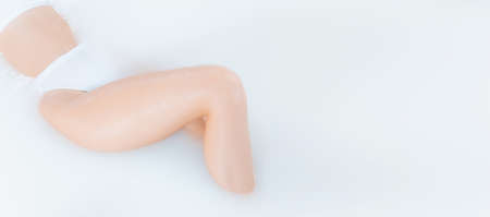Flyer. Close up female body in the milk bath with soft white glowing. Copyspace for advertising....
