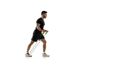 Flyer. Caucasian professional sportsman training isolated on white studio background. Muscular,...