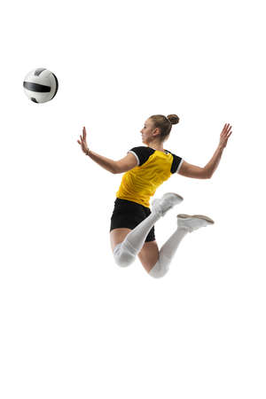 Flying. Young female volleyball player isolated on white studio background. Woman in sportswear training and practicing in action, flight. Concept of sport, healthy lifestyle, motion and movement.の写真素材