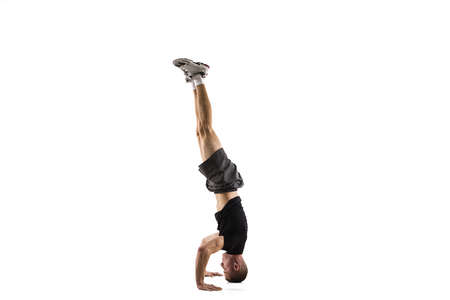 Balanced. Young caucasian male model in action, motion isolated on white background with copyspace....