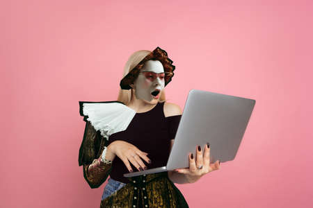 Shicked woman with notebook. Magazine style collage with model outfit mixed of different eras. Copyspace for ad. Trendy colors, modern and vintage, renaissansse fashion. Cintemporary art collage.の写真素材