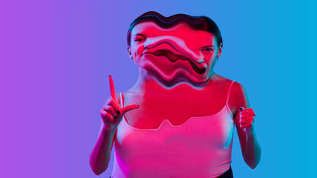 Mental health concept in creative way. Woman with different emotions connected by colorful wave. Splitting personality, displayed and hidden feelings. Happe, cheerful and disappointed, depressed.の写真素材