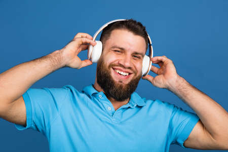 Caucasian mans portrait isolated on blue studio background with copyspace