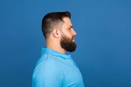 Caucasian mans portrait isolated on blue studio background with copyspaceの写真素材