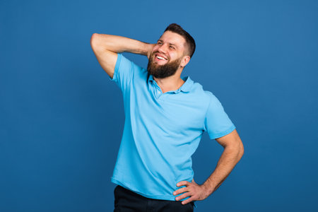 Caucasian mans portrait isolated on blue studio background with copyspaceの写真素材