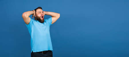 Caucasian mans portrait isolated on blue studio background with copyspace
