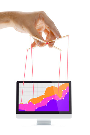 Businessman keeping the growth in economy, manipulating graphs like puppetの写真素材