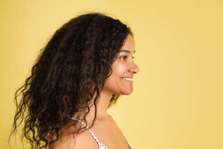 African-american woman portrait isolated on yellow studio background with copyspaceの写真素材