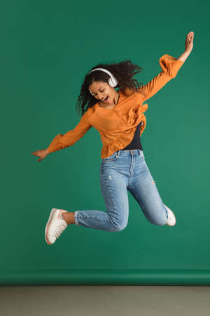 African-american woman portrait isolated on green studio background with copyspace