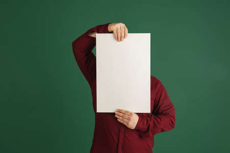 Handsome caucasian man portrait isolated on green studio background with copyspaceの写真素材