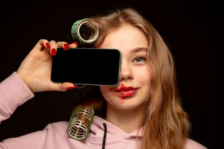 Lie and another life in social media. Girl wearing make up on her face to hide bruises. Playing, pretending happy life.の写真素材