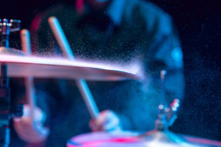 Drummers rehearsing on drums before rock concert. Man recording music on drumset in studioの写真素材