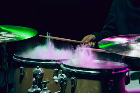 Drummers rehearsing on drums before rock concert. Man recording music on drumset in studioの写真素材