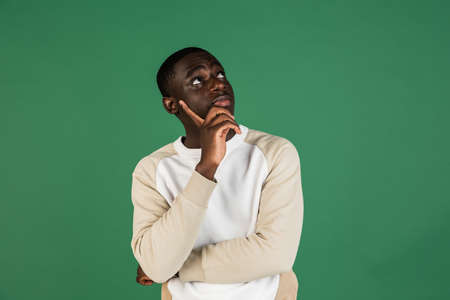 African mans portrait isolated on green studio background with copyspaceの写真素材