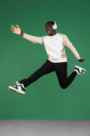 African mans portrait isolated on green studio background with copyspaceの写真素材