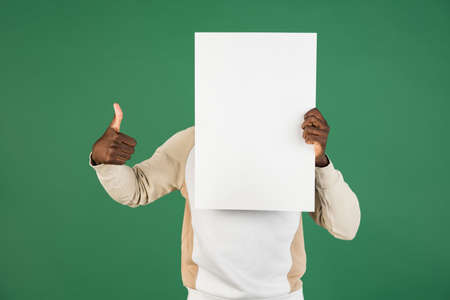African mans portrait isolated on green studio background with copyspace