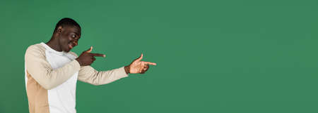 African mans portrait isolated on green studio background with copyspaceの写真素材