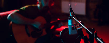 Close-up of musician performing in neon light. Concept of advertising, hobby, music, festival, entertainment.の写真素材