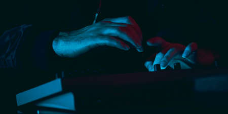 Close-up of musician performing in neon light. Concept of advertising, hobby, music, festival, entertainment.の写真素材