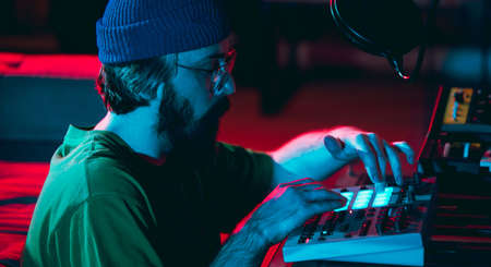 Close-up of musician performing in neon light. Concept of advertising, hobby, music, festival,...