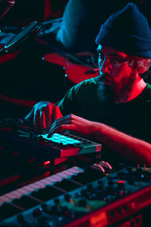 Close-up of musician performing in neon light. Concept of advertising, hobby, music, festival,...
