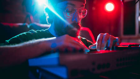 Close-up of musician performing in neon light. Concept of advertising, hobby, music, festival, entertainment.の写真素材
