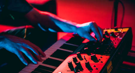 Close-up of musician performing in neon light. Concept of advertising, hobby, music, festival,...