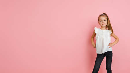Pretty caucasian girl portrait isolated on pink studio background with copyspaceの写真素材