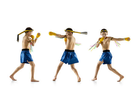 Little boy exercising thai boxing on white background. Fighter practicing, training in martial arts...