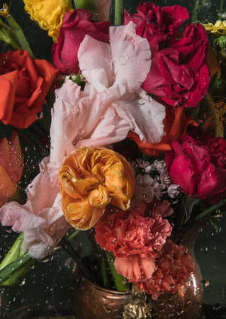 Greeting card to Mother's, Parent's day. Retro styled, copyspace. Bouquet under glass with water drops. Beautiful floral composition. Celebrating, spring and summer mood, family concept. Feminine look.の写真素材