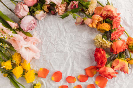 Rounded bright gradient flowers on creased background. Greeting card to Mother's, Parent's day. Beautiful mock up with copyspace. Celebrating, spring and summer mood, family concept. Feminine look.の写真素材