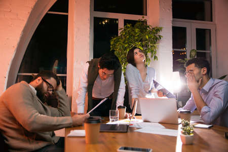 Colleagues working together in modern office using devices and gadgets during creative meeting