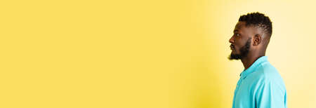Portrait of young African man isolated over yellow studio background with copyspace.の写真素材