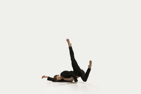 Man in casual style clothes jumping and dancing isolated on white background. Art, motion, action,...