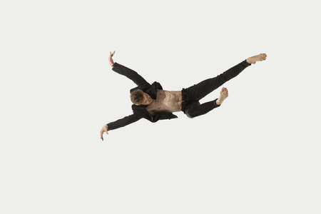 Man in casual style clothes jumping and dancing isolated on white background. Art, motion, action,...
