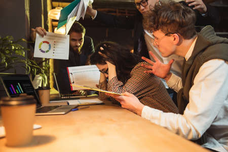 Colleagues working together in modern office using devices and gadgets during creative meeting