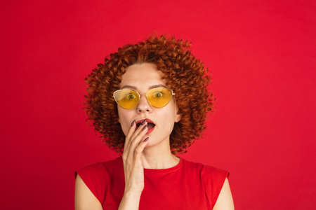 Caucasian womans portrait isolated over red studio background with copyspaceの写真素材
