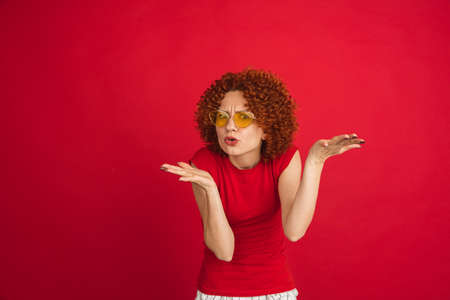Caucasian womans portrait isolated over red studio background with copyspaceの写真素材