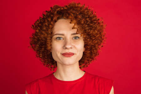 Caucasian womans portrait isolated over red studio background with copyspace
