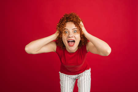 Caucasian womans portrait isolated over red studio background with copyspace