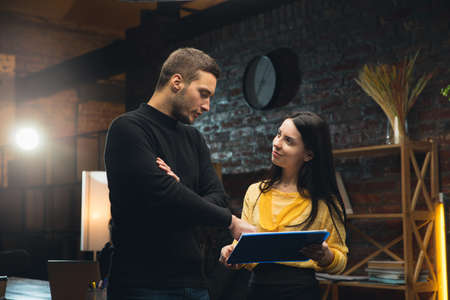 Colleagues working together in modern office using devices and gadgets during creative meetingの写真素材