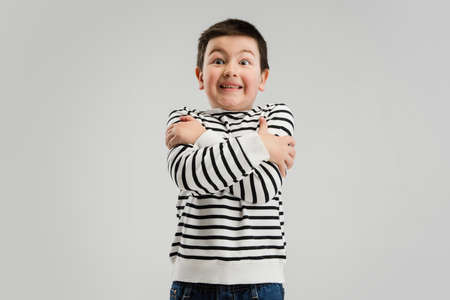 Caucasian boy isolated on white studio background. Copyspace. Childhood, education, emotions concept