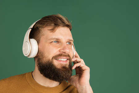 Caucasian mans portrait isolated over green studio background with copyspace