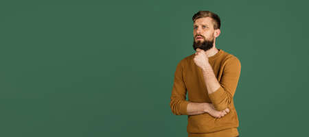 Caucasian mans portrait isolated over green studio background with copyspace