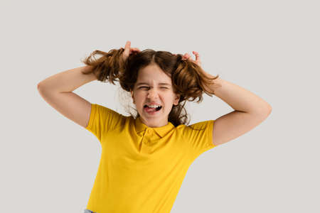Caucasian girl isolated on white studio background. Copyspace. Childhood, education, emotions...