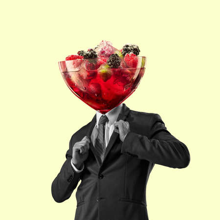 Contemporary art collage, modern design. Retro style. Man headed with tasty cocktail with berries on pastel backgroundの写真素材