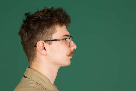 Caucasian mans portrait isolated over green studio background with copyspaceの写真素材