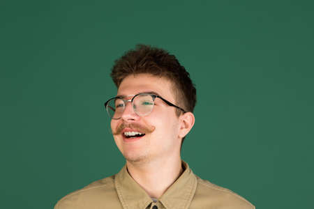 Caucasian mans portrait isolated over green studio background with copyspaceの写真素材